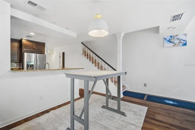 a kitchen with stainless steel appliances granite countertop a refrigerator and a sink