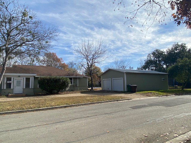 1034 Magnolia Street Lockhart, TX 78644 - Photo 1 of 12 View of property exterior featuring an outdoor structure and a detached garage