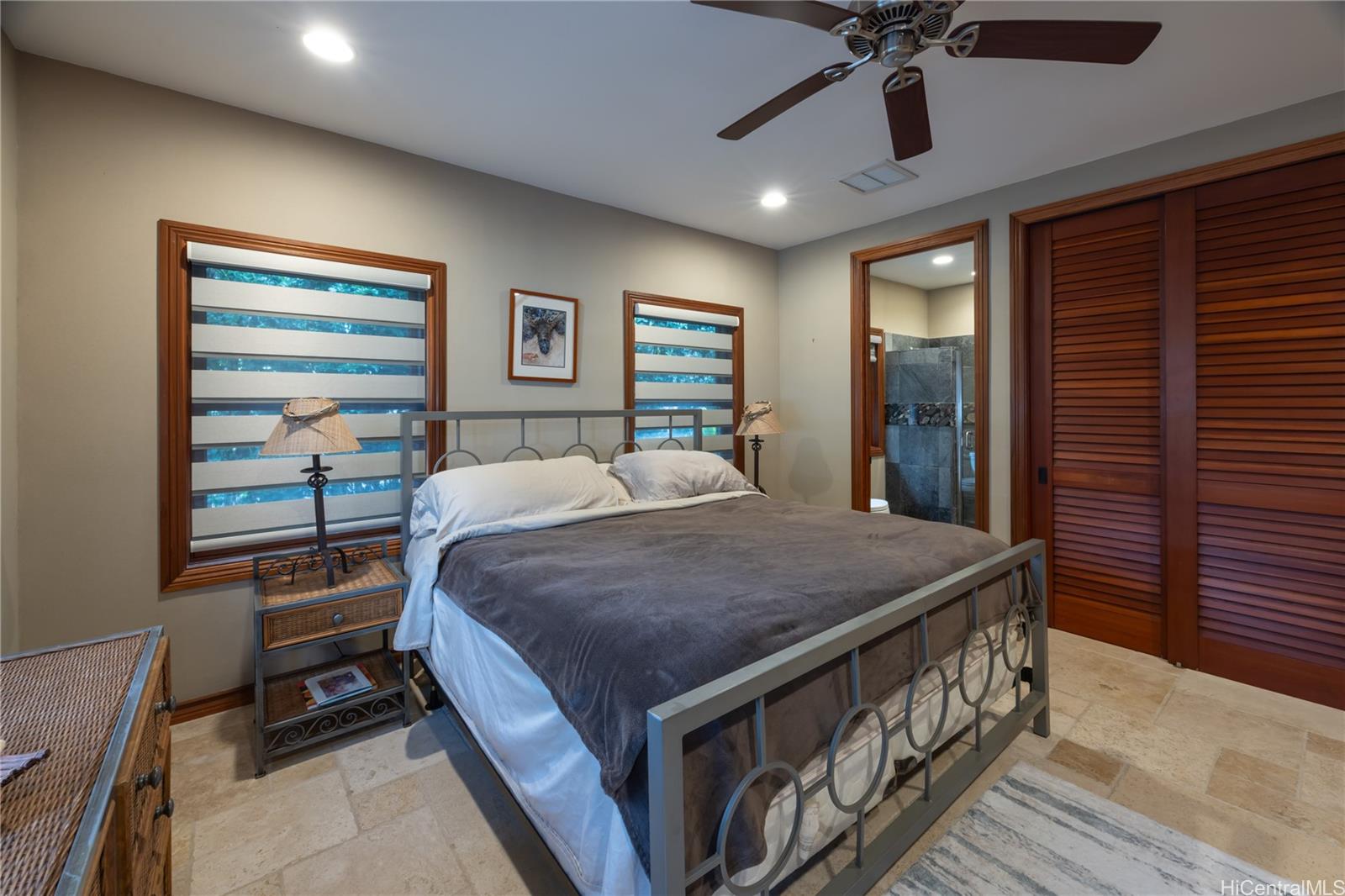 365 Portlock Road Honolulu, HI 96825 - Photo 15 of 25 a bedroom with a bed and a chandelier