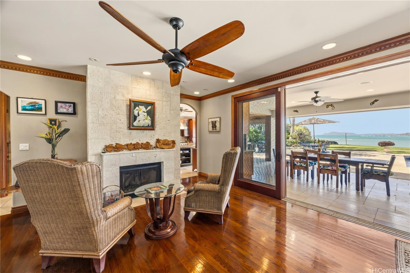 365 Portlock Road Honolulu, HI 96825 - Photo 4 of 25 a living room with furniture a fireplace and a floor to ceiling window