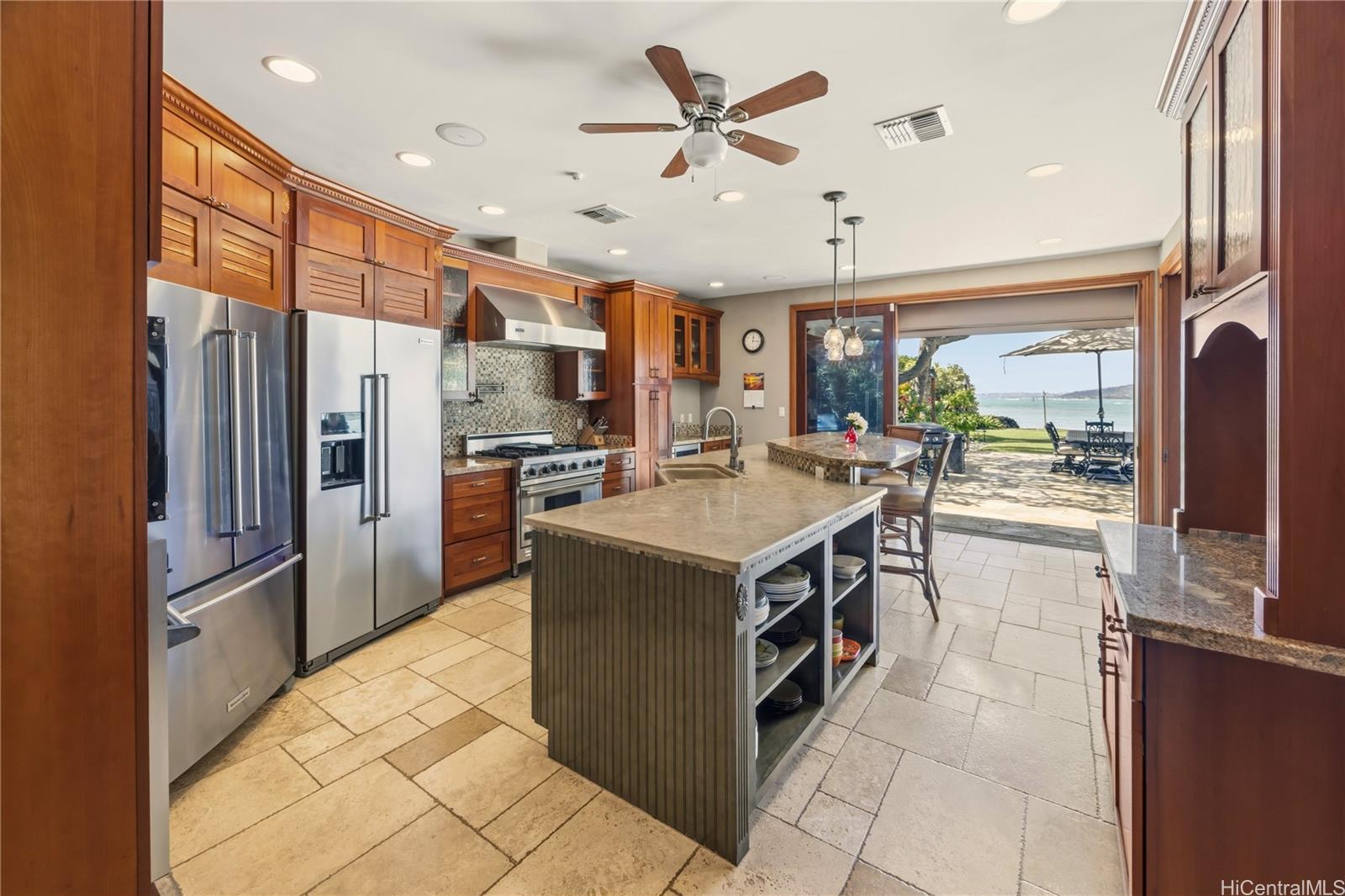 365 Portlock Road Honolulu, HI 96825 - Photo 8 of 25 a kitchen with stainless steel appliances a stove a refrigerator a sink a oven with a dining table and chairs