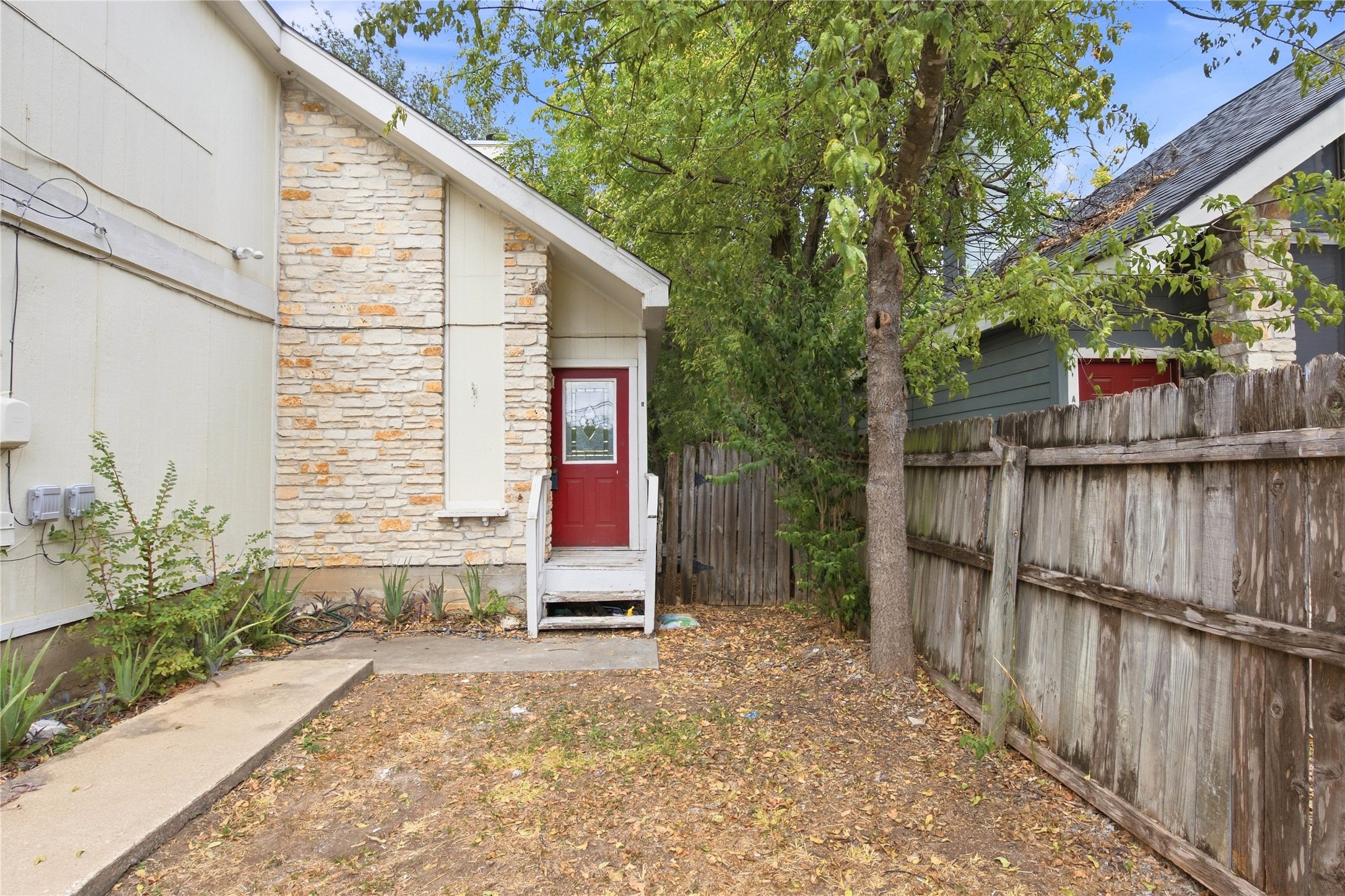 2500 Jones Road, Unit B Austin, TX 78745 - Photo 14 of 37 An inviting stone facade accents the private entry nestled behind a wooden privacy fence.