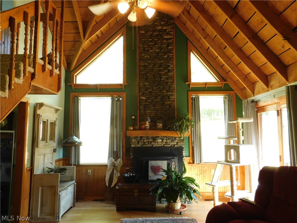 1404 Jericho Road Walker, WV 26180 - Photo 12 of 30 Now to this sitting, reading room with it's majestic stone fireplace. Beautiful space! Lighting all natural, wood flooring and feeling of warmth and peace.