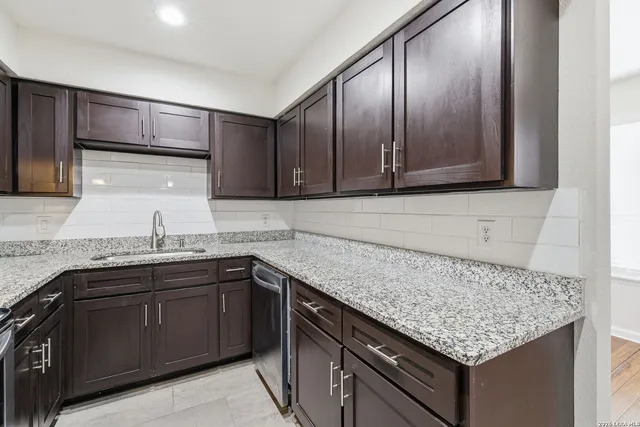 a kitchen with a sink and cabinets