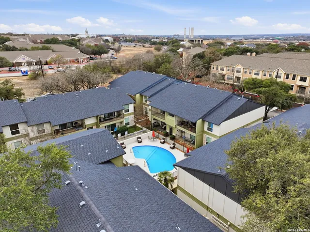 an aerial view of residential houses with outdoor space and river