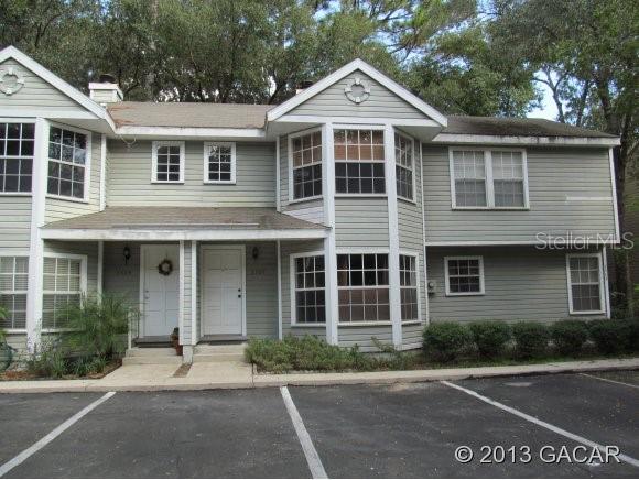 2307 Southwest 73rd Terrace Gainesville, FL 32607 - Photo 1 of 1 a front view of a house with a yard