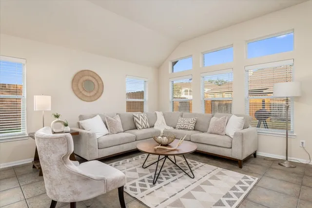 a living room with furniture and a large window