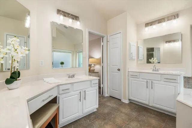 a spacious bathroom with a granite countertop sink and a mirror