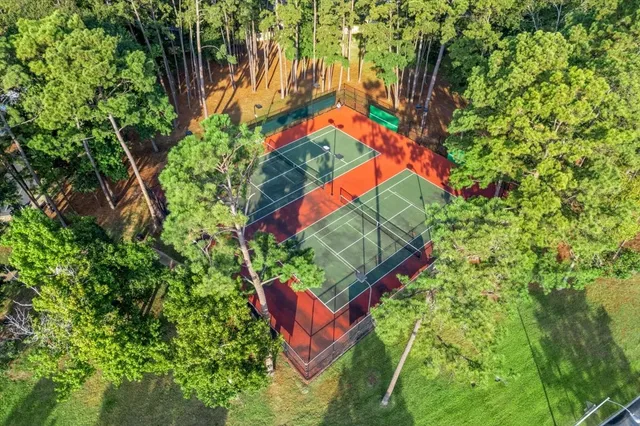 an aerial view of residential houses with outdoor space and lake view