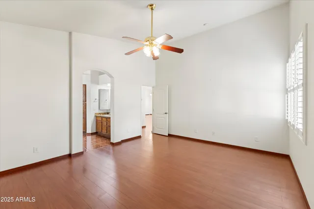 a spacious bedroom with a bed and a couch