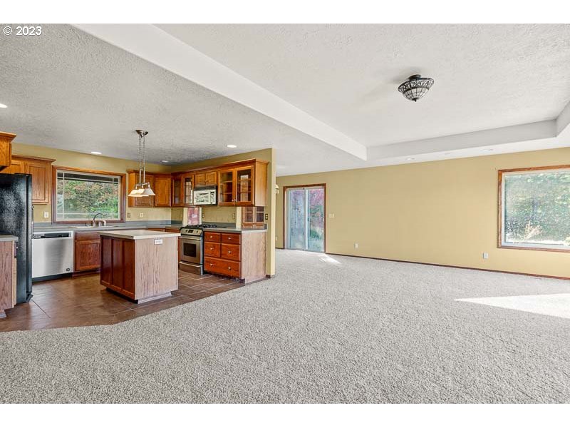 6295 Kings Ridge Road Dallas, OR 97338 - Photo 14 of 44 a view of a livingroom with furniture and a kitchen