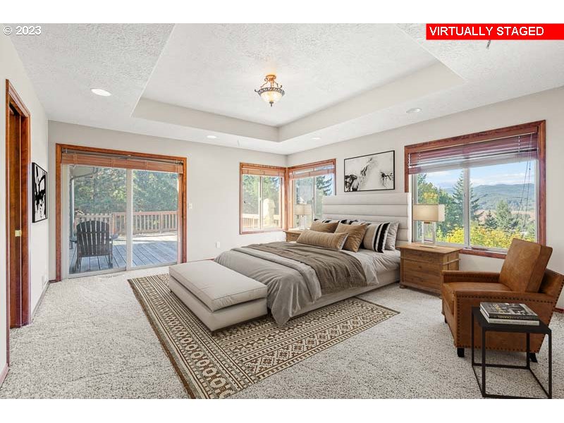 6295 Kings Ridge Road Dallas, OR 97338 - Photo 16 of 44 a spacious bedroom with a bed and glass window