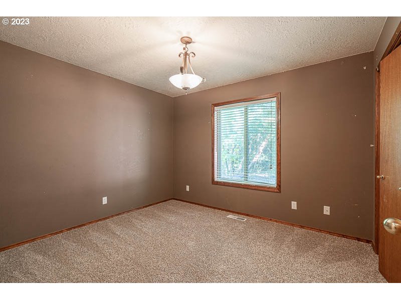 6295 Kings Ridge Road Dallas, OR 97338 - Photo 22 of 44 a view of an empty room with a window