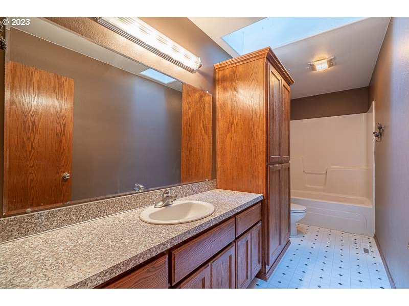 6295 Kings Ridge Road Dallas, OR 97338 - Photo 24 of 44 a bathroom with a sink a mirror and a shower