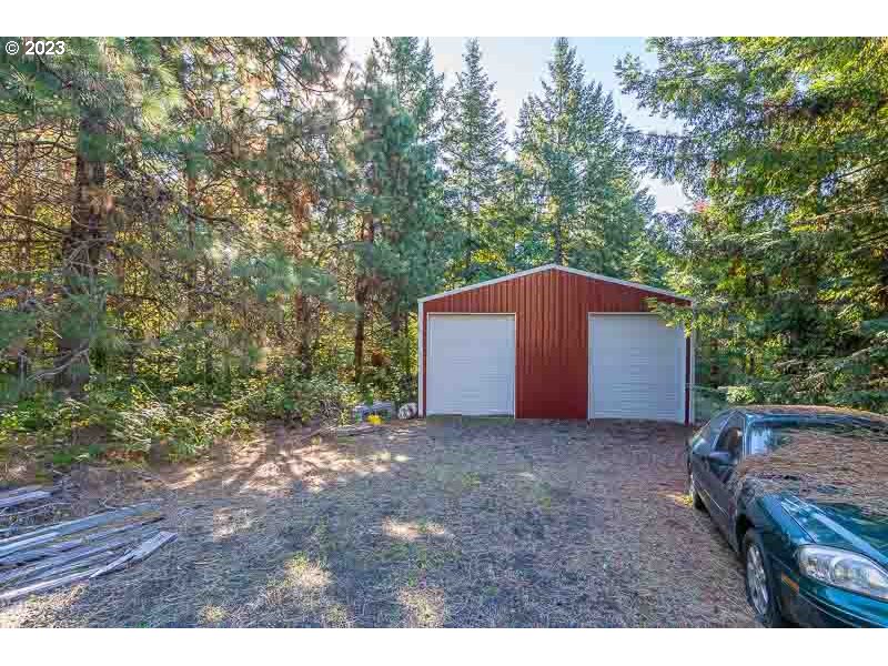 6295 Kings Ridge Road Dallas, OR 97338 - Photo 30 of 44 a backyard of a house with large trees and wooden fence