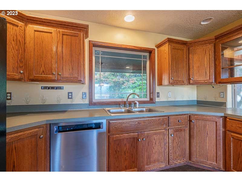 6295 Kings Ridge Road Dallas, OR 97338 - Photo 7 of 44 a kitchen with stainless steel appliances granite countertop a sink and cabinets