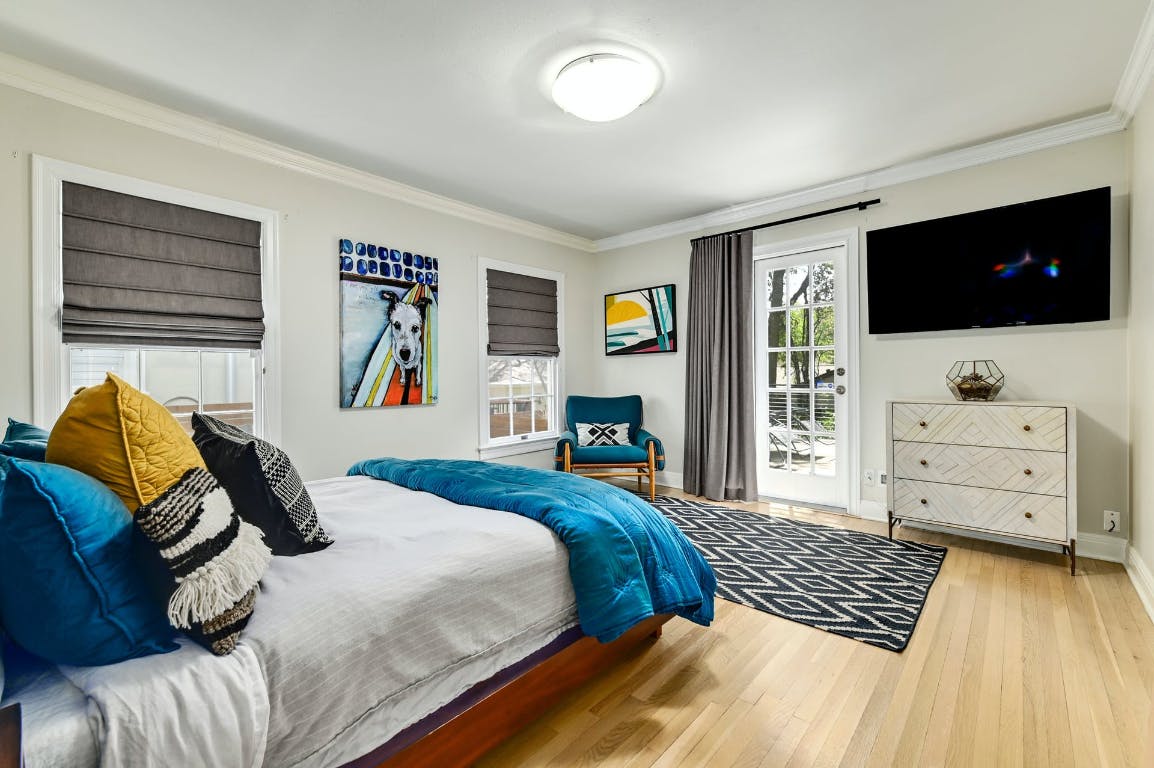 3321 Windsor Road Austin, TX 78703 - Photo 12 of 28 a bedroom with a bed and a flat screen tv