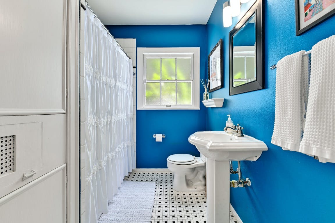 3321 Windsor Road Austin, TX 78703 - Photo 13 of 28 a bathroom with a sink toilet and a mirror