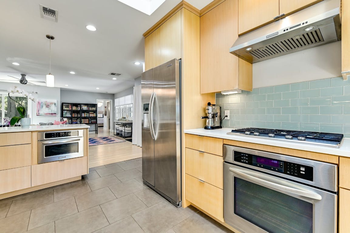 3321 Windsor Road Austin, TX 78703 - Photo 5 of 28 a kitchen with a stove and a refrigerator
