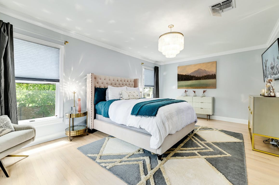 3321 Windsor Road Austin, TX 78703 - Photo 8 of 28 a bedroom with a bed and a flat screen tv