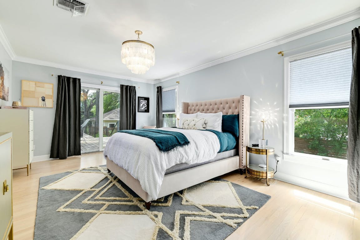 3321 Windsor Road Austin, TX 78703 - Photo 9 of 28 a bedroom with a bed and a large window