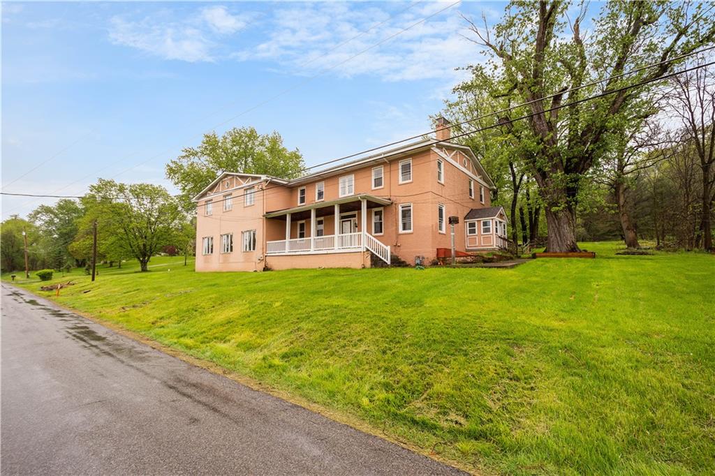36 Little Mingo Road Finleyville, PA 15332 - Photo 2 of 50 a front view of a house with garden and trees