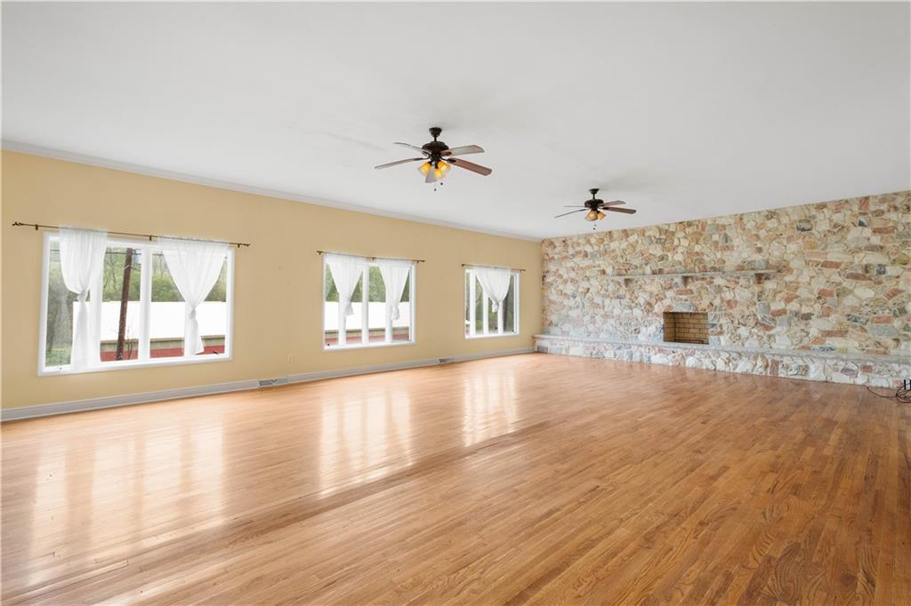 36 Little Mingo Road Finleyville, PA 15332 - Photo 22 of 50 a view of a livingroom with wooden floor and a ceiling fan