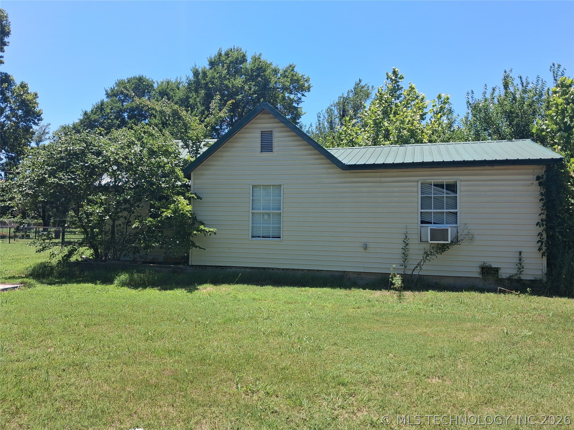 805 Southwest 4th Street Jones, OK 73049 - Photo 1 of 4 Siding exterior with a green metal roof