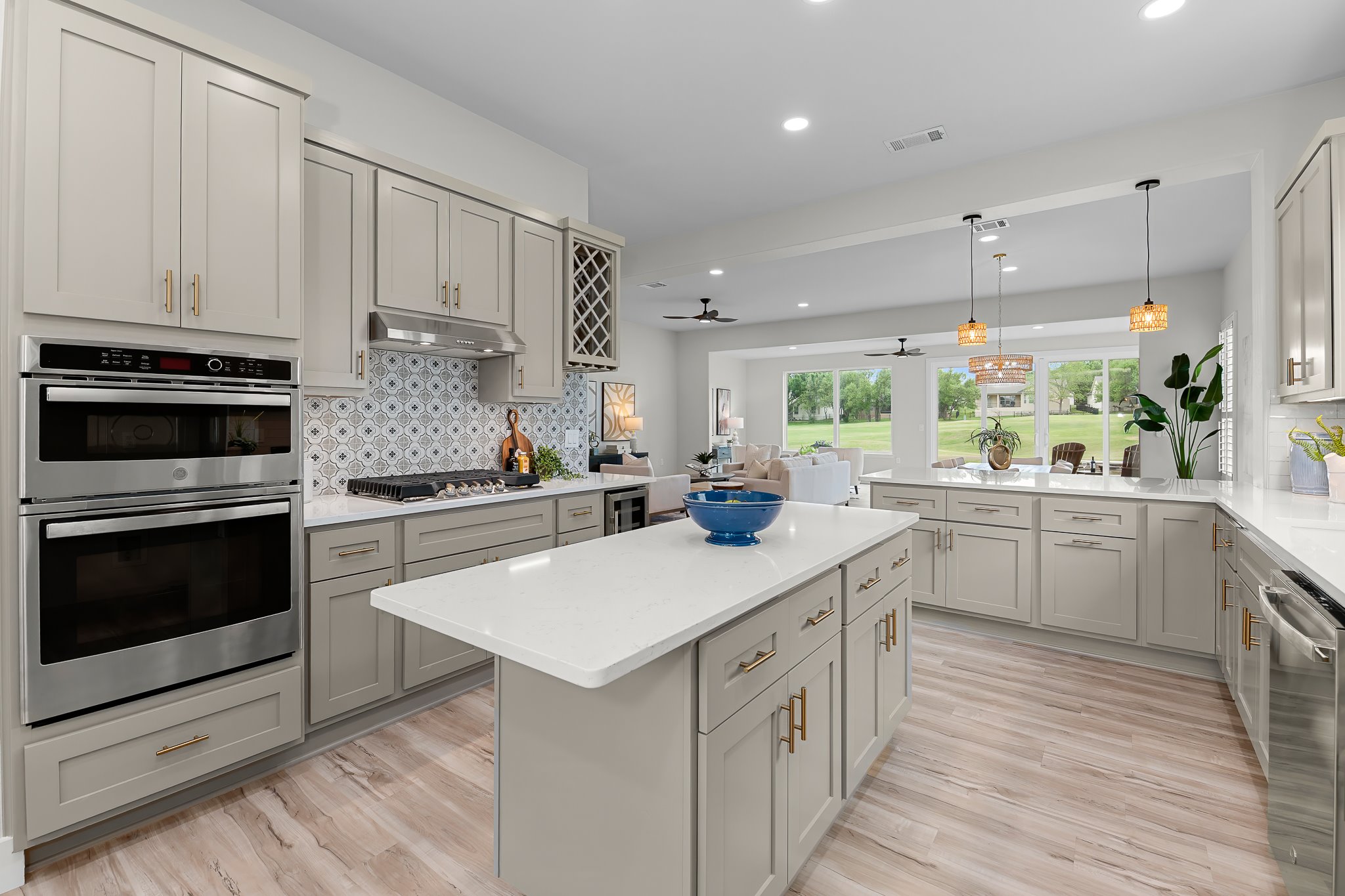 Quartz counters, custom backsplash, and new appliances are part of this new kitchen