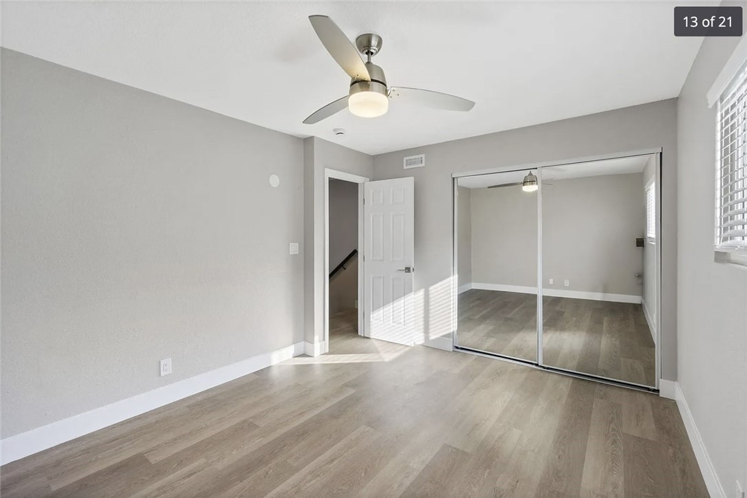 1024 Mission Drive, Unit B Costa Mesa, CA 92626 - Photo 2 of 15 an empty space with wooden floor and a ceiling fan