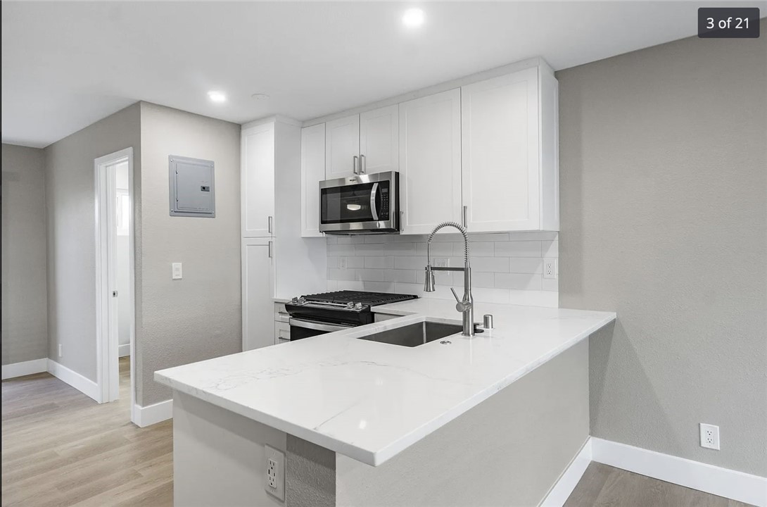 1024 Mission Drive, Unit B Costa Mesa, CA 92626 - Photo 5 of 15 a kitchen with stainless steel appliances a stove a sink and a refrigerator