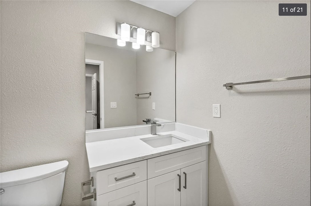 1024 Mission Drive, Unit B Costa Mesa, CA 92626 - Photo 9 of 15 a bathroom with a sink a toilet and a mirror