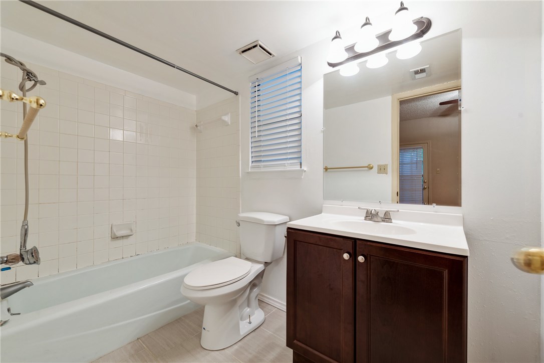 706 West 22nd Street, Unit 202 Austin, TX 78705 - Photo 12 of 24 a bathroom with a sink toilet a mirror and shower