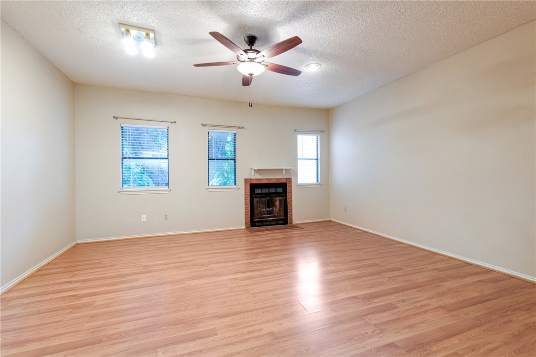 706 West 22nd Street, Unit 202 Austin, TX 78705 - Photo 5 of 24 wooden floor in an empty room with a fireplace