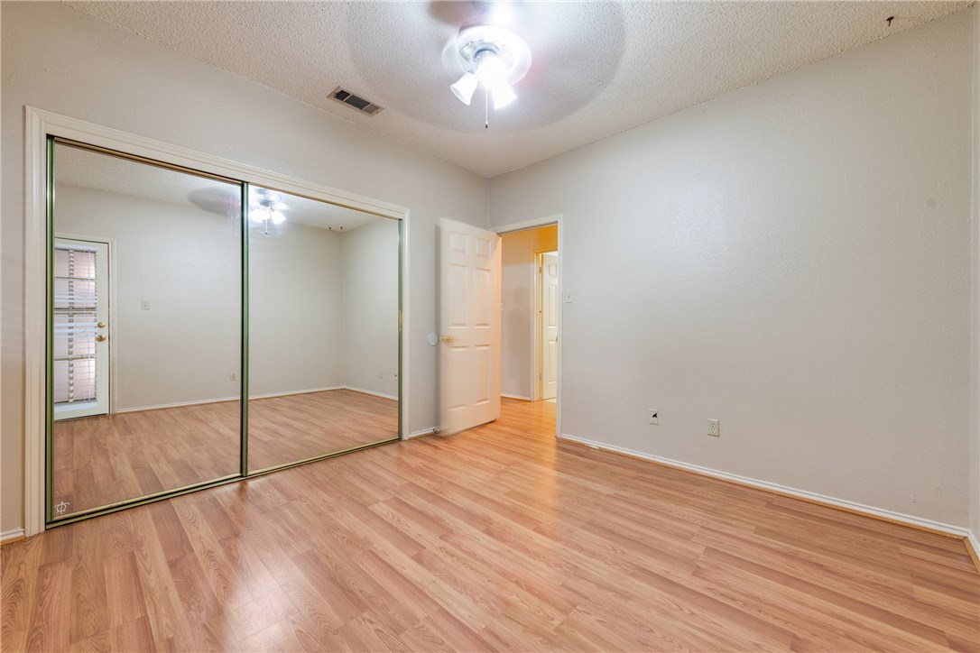 706 West 22nd Street, Unit 202 Austin, TX 78705 - Photo 6 of 24 a view of an empty room with wooden floor and a bathroom