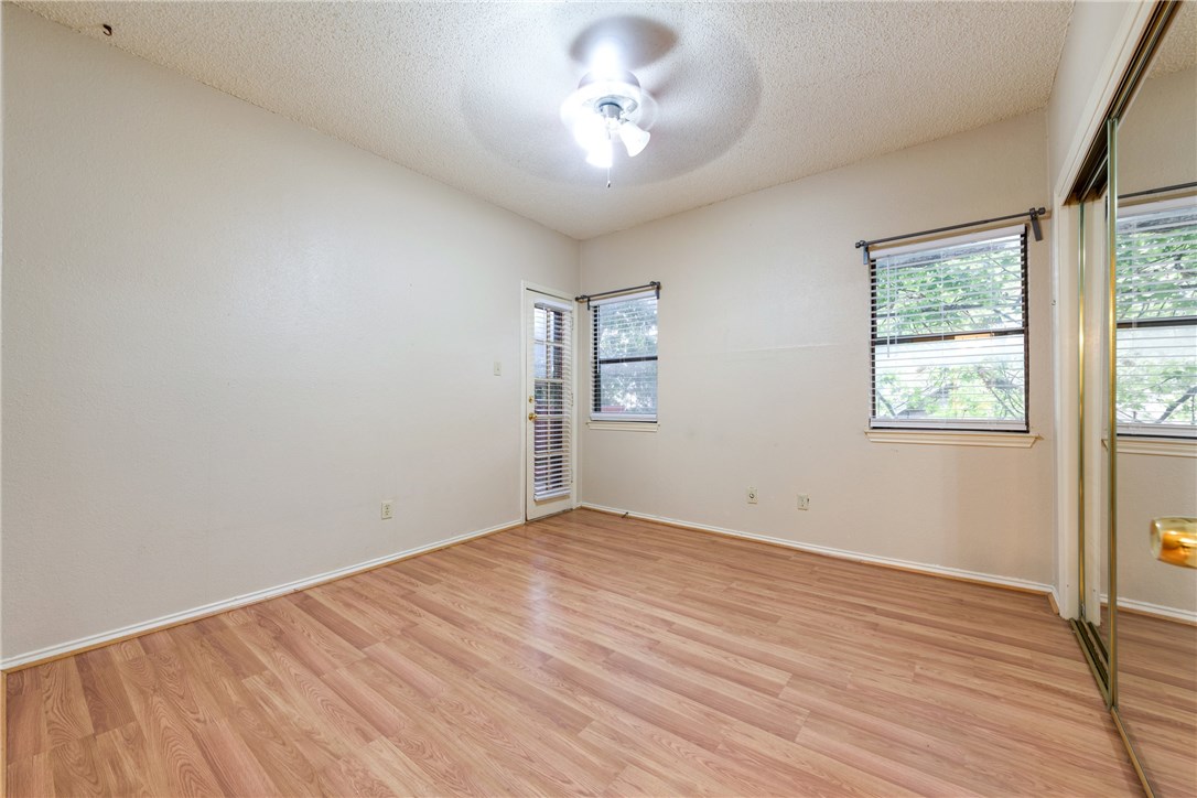 706 West 22nd Street, Unit 202 Austin, TX 78705 - Photo 8 of 24 wooden floor in an empty room with a window