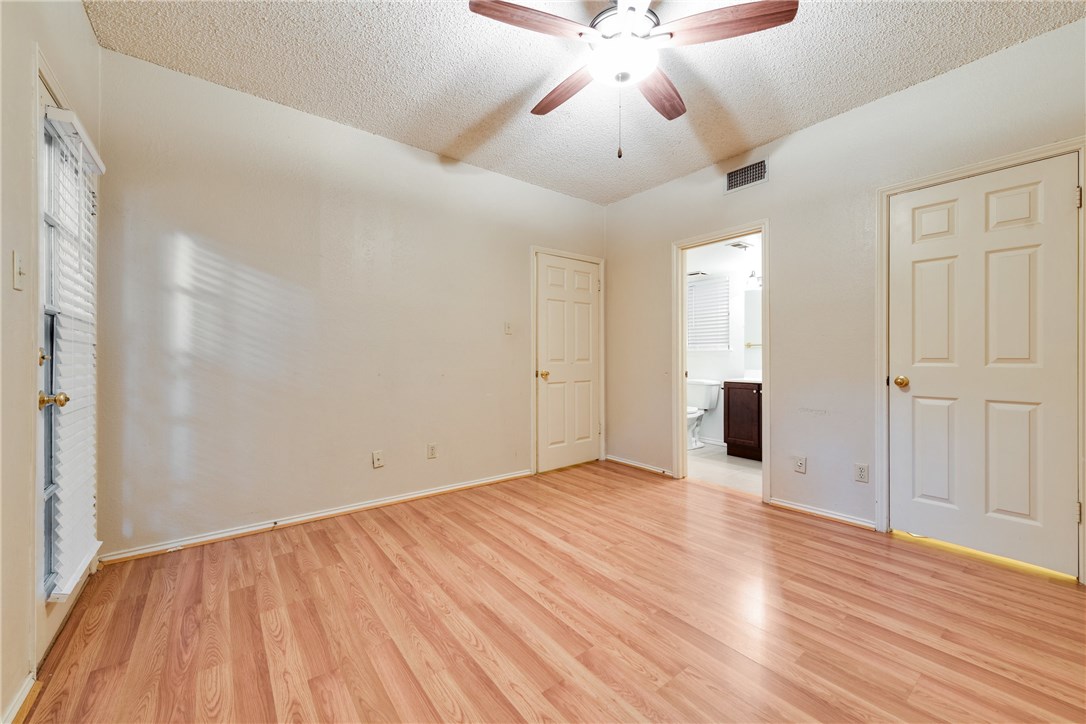 706 West 22nd Street, Unit 202 Austin, TX 78705 - Photo 9 of 24 an empty room with wooden floor and windows
