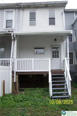 a view of a house with a small deck