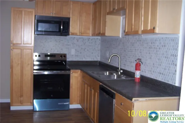 a kitchen with granite countertop a sink and a stove