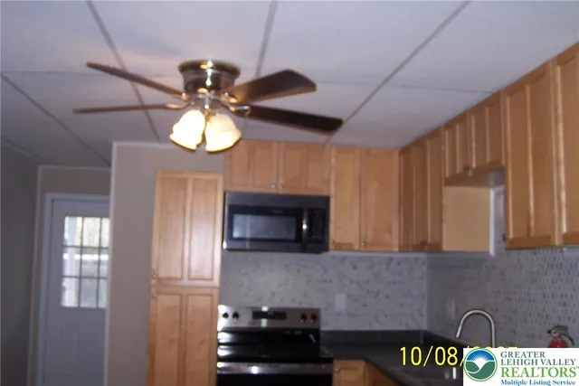 a kitchen with cabinets and chandelier