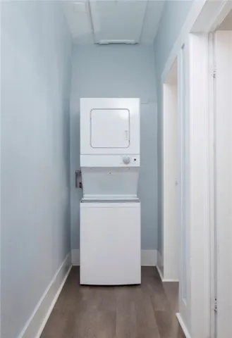 a utility room with wooden floor washer and dryer