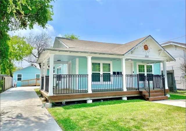 a view of a house with a yard and deck