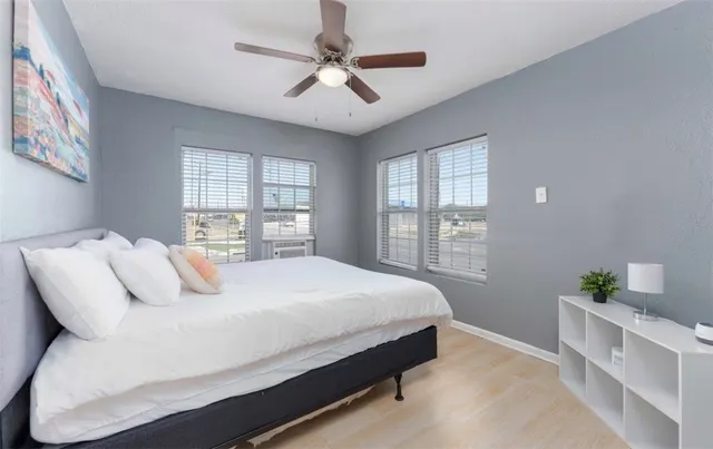 a bedroom with a large bed and a window