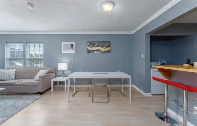 a living room with furniture a window and a table
