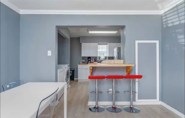 a room with a table chairs and a table