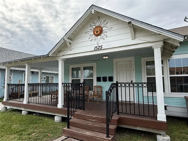 a view of a house with a wooden deck