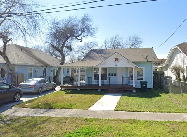 a front view of a house with a yard table and chairs