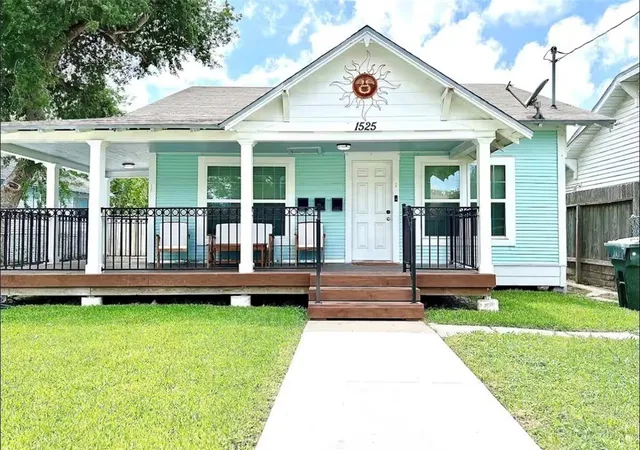 a view of a house with a yard and deck