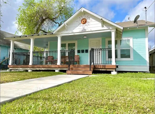 a view of a house with a yard and sitting area