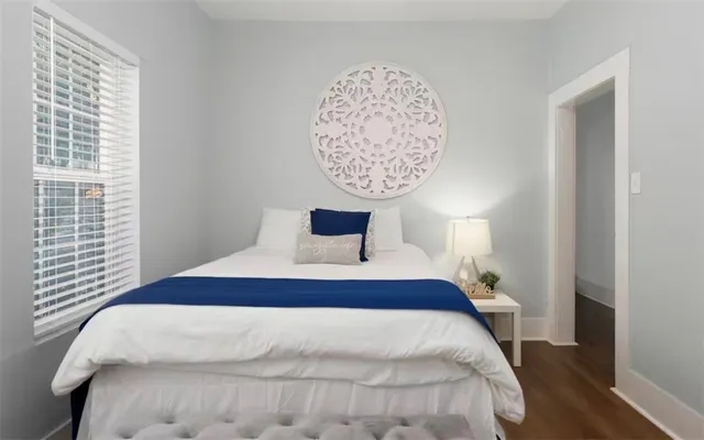 a bedroom with a bed and a night stand